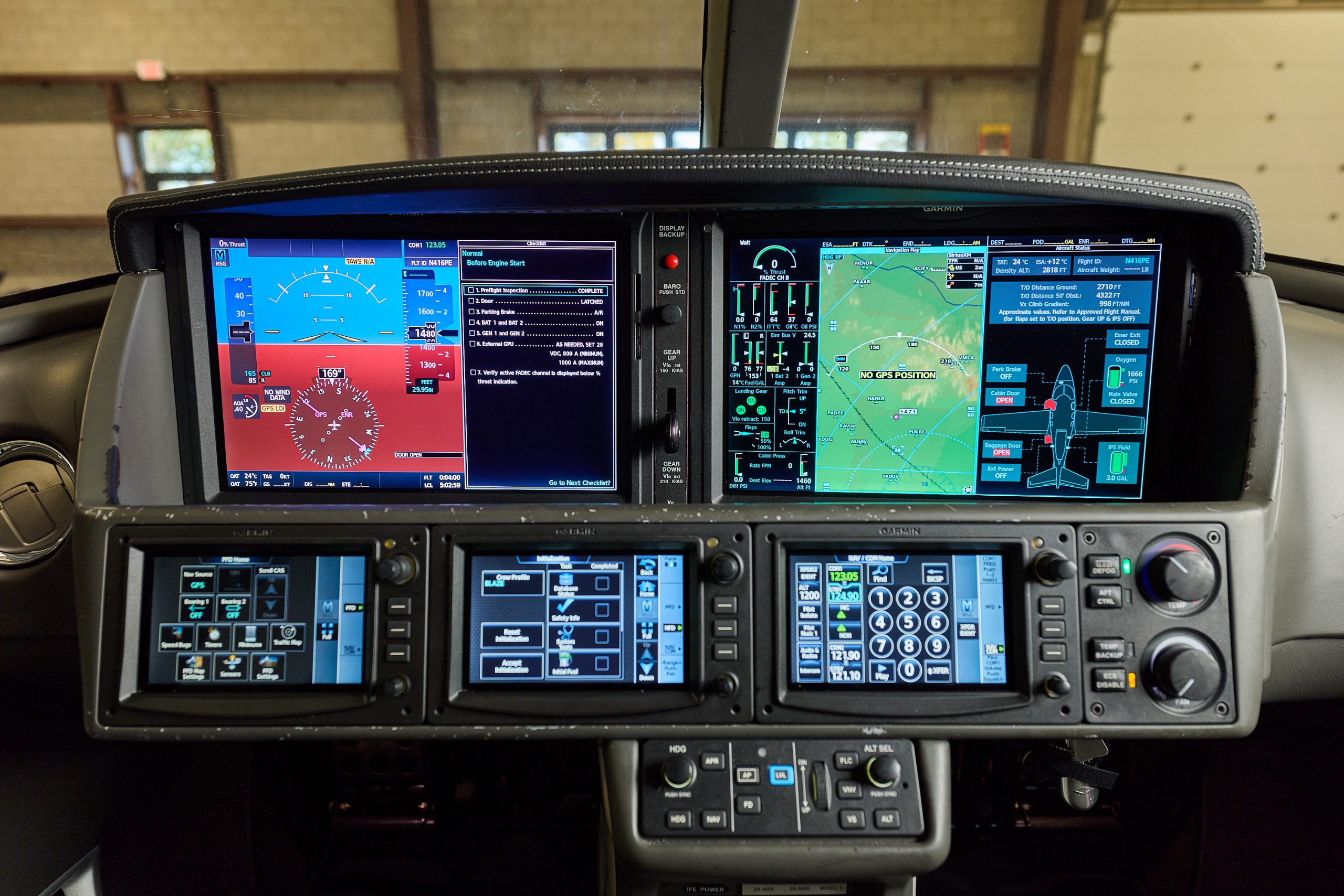 Modern airplane cockpit with Garmin glass avionics, flight instruments and GPS navigation displays in instrument panel.